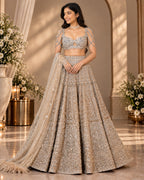 Champagne gold embroidered lehenga set with embellished blouse and dupatta by Silai Parampara Studio
