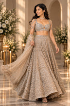 Detailed front view of champagne gold embroidered bridal lehenga with intricate embroidery and dupatta