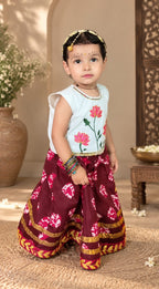Front view of maroon girls lehenga with lotus embroidered blouse and gold border