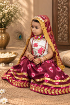 Maroon girls festive lehenga with gold trim and peacock feather detail