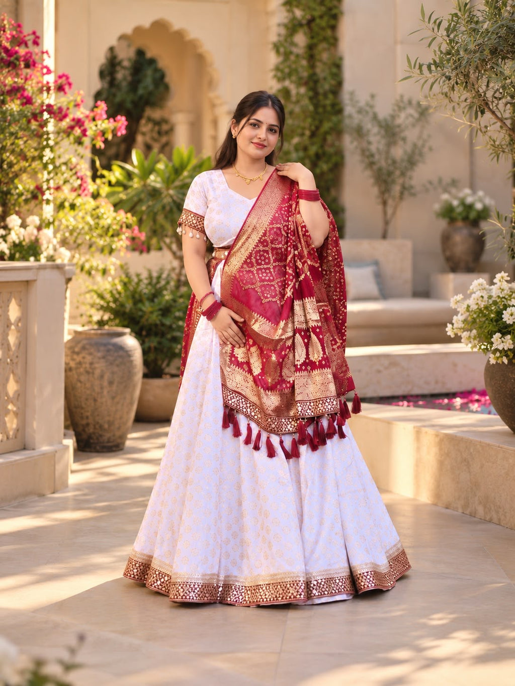 Noor ivory and maroon embroidered lehenga set with gold motifs and tassel dupatta, full-length front view