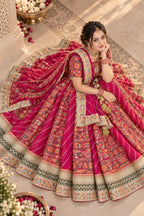 Close view of rani pink printed lehenga, choli and embellished dupatta details